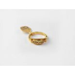 An 18ct gold ring set with five graduated diamonds, with beaded borders, stamped 750, size L,