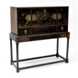 An Oriental-style cabinet on stand with simple Chinoiserie-style decoration, the fall front