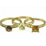 Three 9ct gold dress rings, each with different coloured single stone and tiny baguette stones to