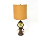 A novelty ship's lamp, with brass column supporting vintage hessian shade, over ship's telegraph,