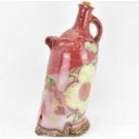 A large studio pottery vessel in the form of a tall flagon leaning, painted with enamelled floral