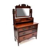 An early 20th century walnut dressing chest with bevelled mirror plate above two short jewellery