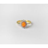 An 18ct gold cluster ring set with cabochon orange stone and diamonds, stamped 750, size O1/2,