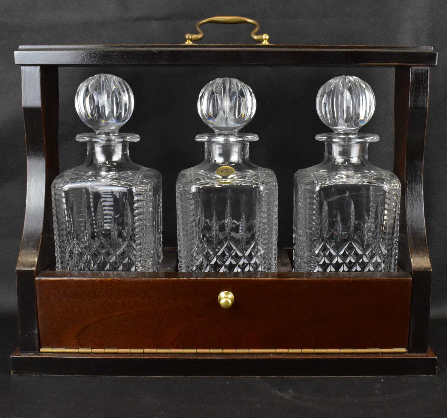 A 20th century mahogany cased three-decanter tantalus, the matching three square English hand made