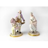 SITZENDORF; a pair of late 19th/early 20th century figures in period costume, both to oval floral