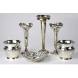 A collection of silver items comprising a pair of pots with embossed floral border, a pierced pin