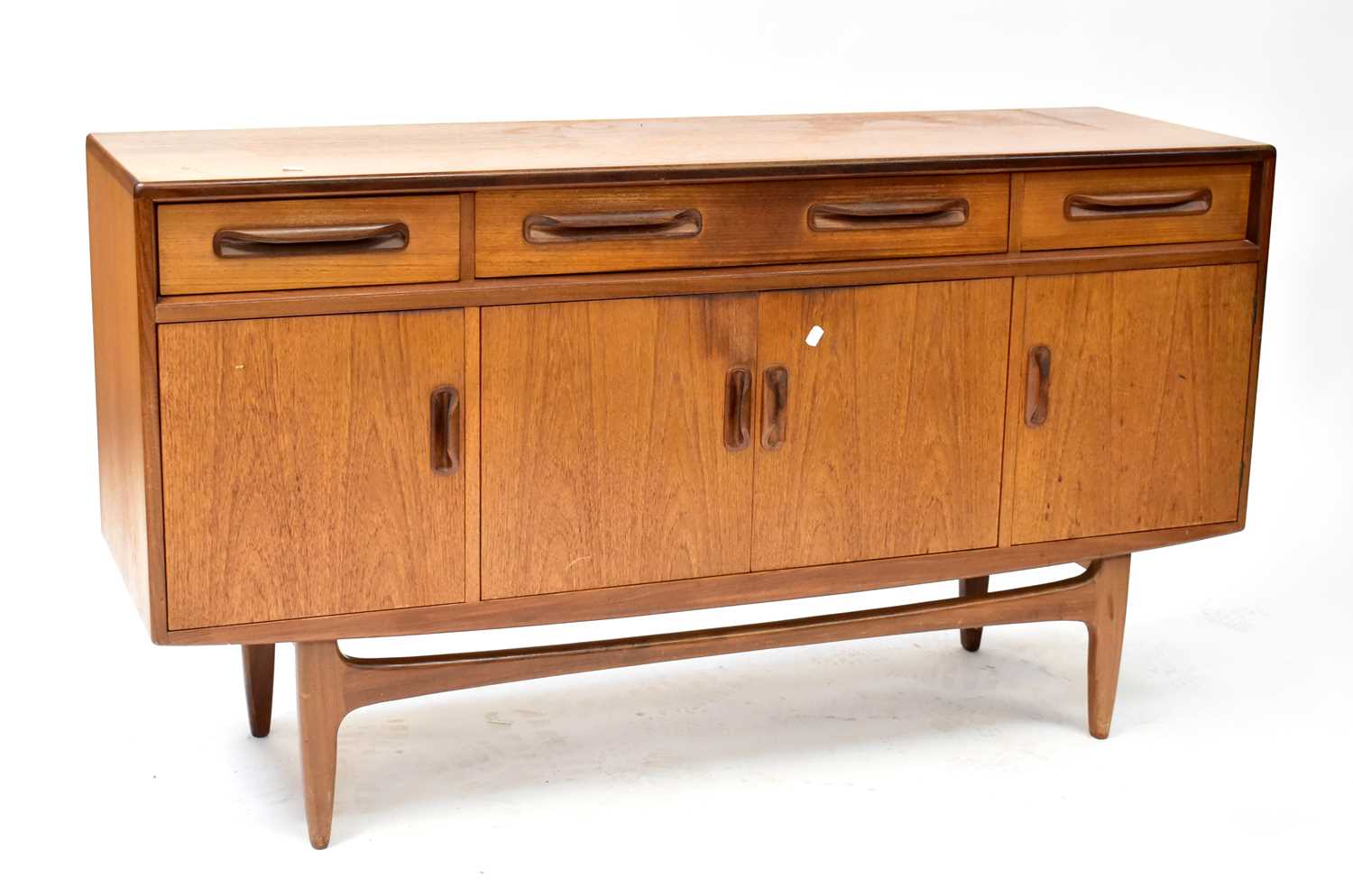 G-PLAN; a 1960s teak sideboard with three frieze drawers above a pair of doors, flanked by a further
