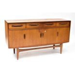 G-PLAN; a 1960s teak sideboard with three frieze drawers above a pair of doors, flanked by a further