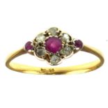 A late 19th/early 20th century 18ct gold ruby and diamond flower head ring, the central ruby in a