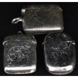 Three late 19th/early 20th century hallmarked silver vesta cases, the tallest of pill shape,