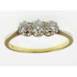 An 18ct gold three-stone diamond ring, the principal stone approx. 0.15ct, flanked either side by