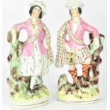 Two 19th century Staffordshire pottery figures of a Highland couple, both wearing tartan, height