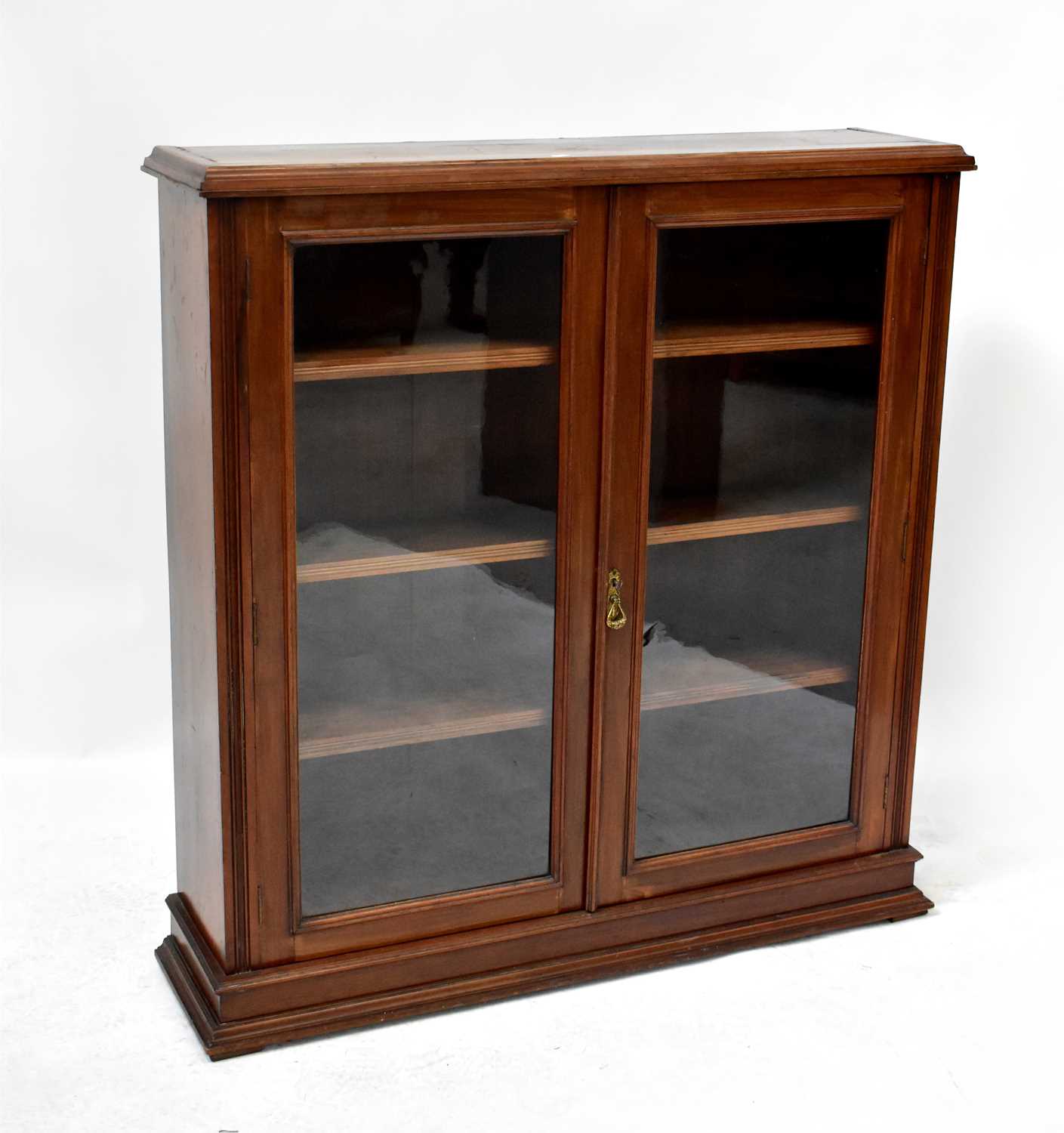 An early 20th century mahogany glazed bookcase with pair of doors and three adjustable interior