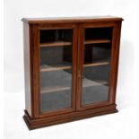 An early 20th century mahogany glazed bookcase with pair of doors and three adjustable interior