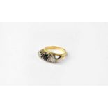 An 18ct gold ring set with central blue stone and two diamonds, approx. 0.2ct, stamped 750, size