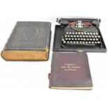 A cased Corona Type 4 1920s portable typewriter, a Victorian Bible, and a Bacon's Excelsior map of
