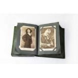 An early 20th century postcard album containing promotional photographs of actors, greetings
