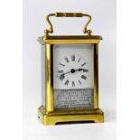 A brass cased carriage clock, the enamelled dial set with Roman numerals and personalised