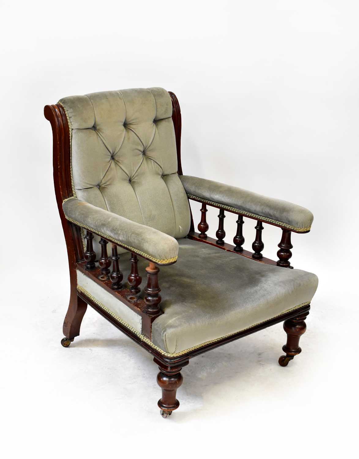 An Edwardian walnut framed open arm elbow chair, upholstered in button pressed sage velour, raised