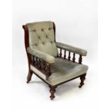 An Edwardian walnut framed open arm elbow chair, upholstered in button pressed sage velour, raised