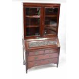 A Victorian mahogany bureau bookcase, the upper section with pair of glazed doors with two