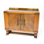 An early 20th century oak sideboard of Art Deco form, twin doors to ball supports, 94 x 121 x 46cm.