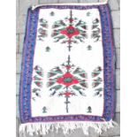 A Far Eastern saddle rug with double floral pattern, on an ivory ground within a blue floral border,