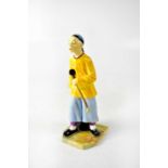 ROYAL WORCESTER; a figure by James Hadley, modelled as a Chinese gentleman holding an opium pipe,