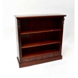 A reproduction mahogany open bookcase with two adjustable shelves above three drawers to plinth