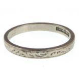 An 18ct white gold wedding band with Celtic design, size R, approx. 3.3g.