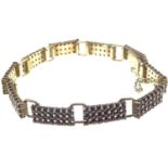 A Continental gilt silver (835 grade) garnet cluster bracelet comprising ten panels of twenty-one