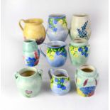 E. RADFORD; nine 1930s vases and jugs hand painted with flowers, tallest 18cm (9).