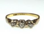 An 18ct gold ring with three diamonds set in white gold, size M/N, approx. 2.3g.