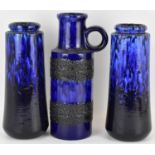 WEST GERMAN POTTERY; three blue drip glaze vases, one in jug form with circular handle, no.401-28,