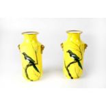 CAULDON LTD; a pair of yellow ground gilt-heightened sleeve vases, gilded lion ring handles and