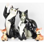 Three porcelain cats, two with glass eyes, and a pair of fawn pottery salt and pepper pots (5).