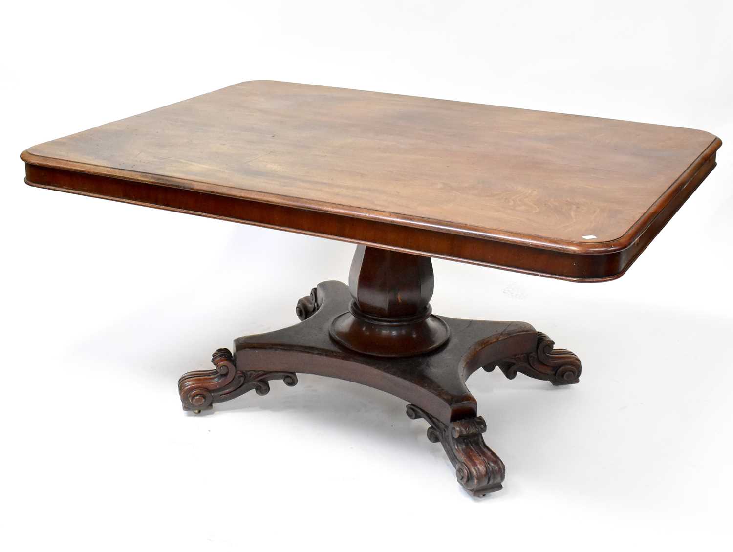 A large 19th century tilt-top table with rounded rectangular top above octagonal baluster column, to