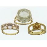 Three 9ct gold dress rings, one with large cut white stone, size P, one with five graduated claw set