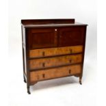 An early 20th century mahogany chest, the upper section with a pair of panelled doors above three