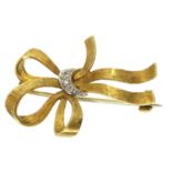 A modern 18ct gold brooch in the form of a tied bow, with a central white gold band of tiny