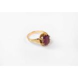 A gold ring set with amethyst and floral engraved shoulders, stamped 800, size M, approx. 4.5g.