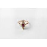 A 14ct gold marquise-shaped ring set with red stone in a surround of diamonds, stamped 585, size