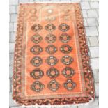 A vintage Turkish rug with six rows of three medallions, on an orange ground with border, 155 x