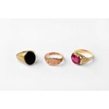 A 14ct gold ring set with red stones together a with a 9ct gold signet ring set with onyx and a