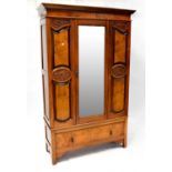 An early 20th century mahogany and burr walnut wardrobe with carved detail and single bevel edge