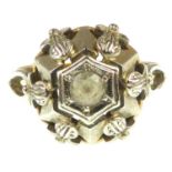 An 18ct gold diamond dress ring with central collet set white stone in a fancy white gold mount,