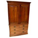 An Edwardian mahogany linen press, the stepped cornice above pair of panel doors enclosing four