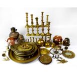 A mixed lot of copper and brassware to include candlesticks, chargers, a 1930s sugar bowl with