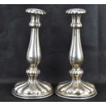 A pair of 19th century Austrian silver candlesticks, the fluted one-piece bodies with weighted
