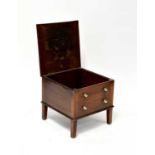 A 19th century mahogany commode in the form of a two-drawer chest, lacking interior, raised on